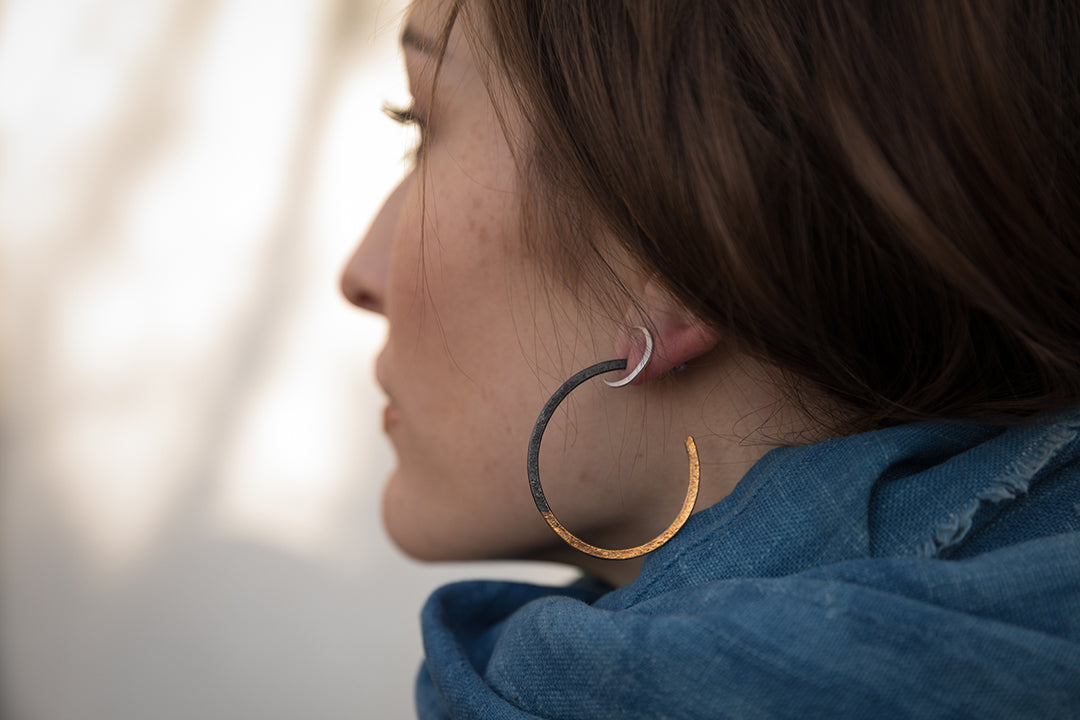 woman wearing Cynthia Jones two tone hoop earring
