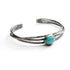 3 hand hammered silver bands hold a turquoise stone